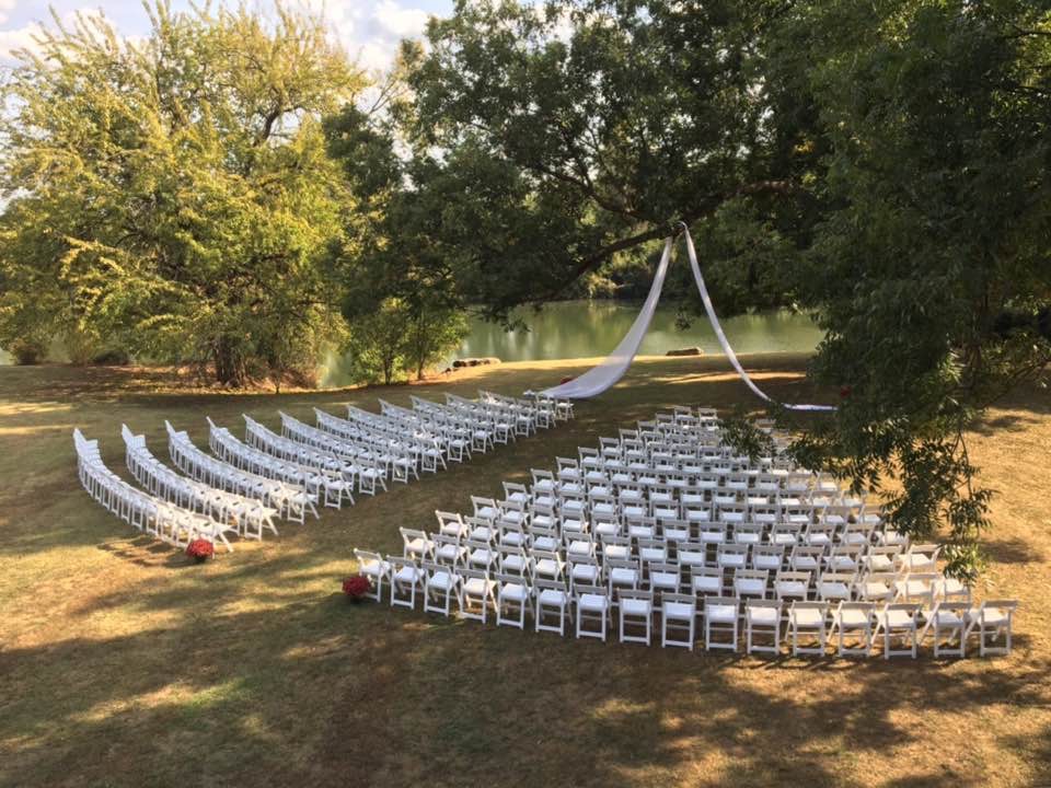 white rental chairs set up for ceremony 