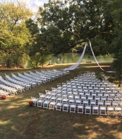 Wedding Ceremony set up with white chairs 