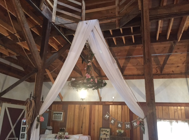 white linen hanging arch for wedding ceremony