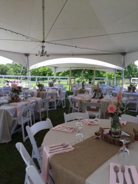white tables and chairs set up for wedding reception.